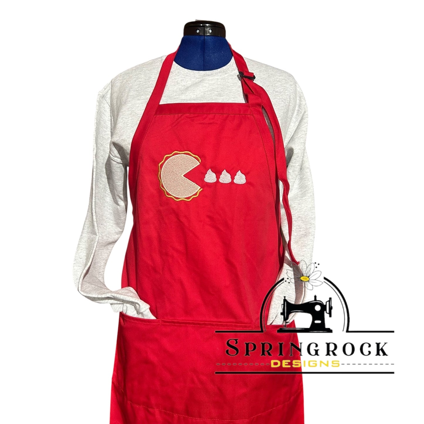 Red apron with a logo on a mannequin against a white background, featuring the brand 'Springrock Designs'.