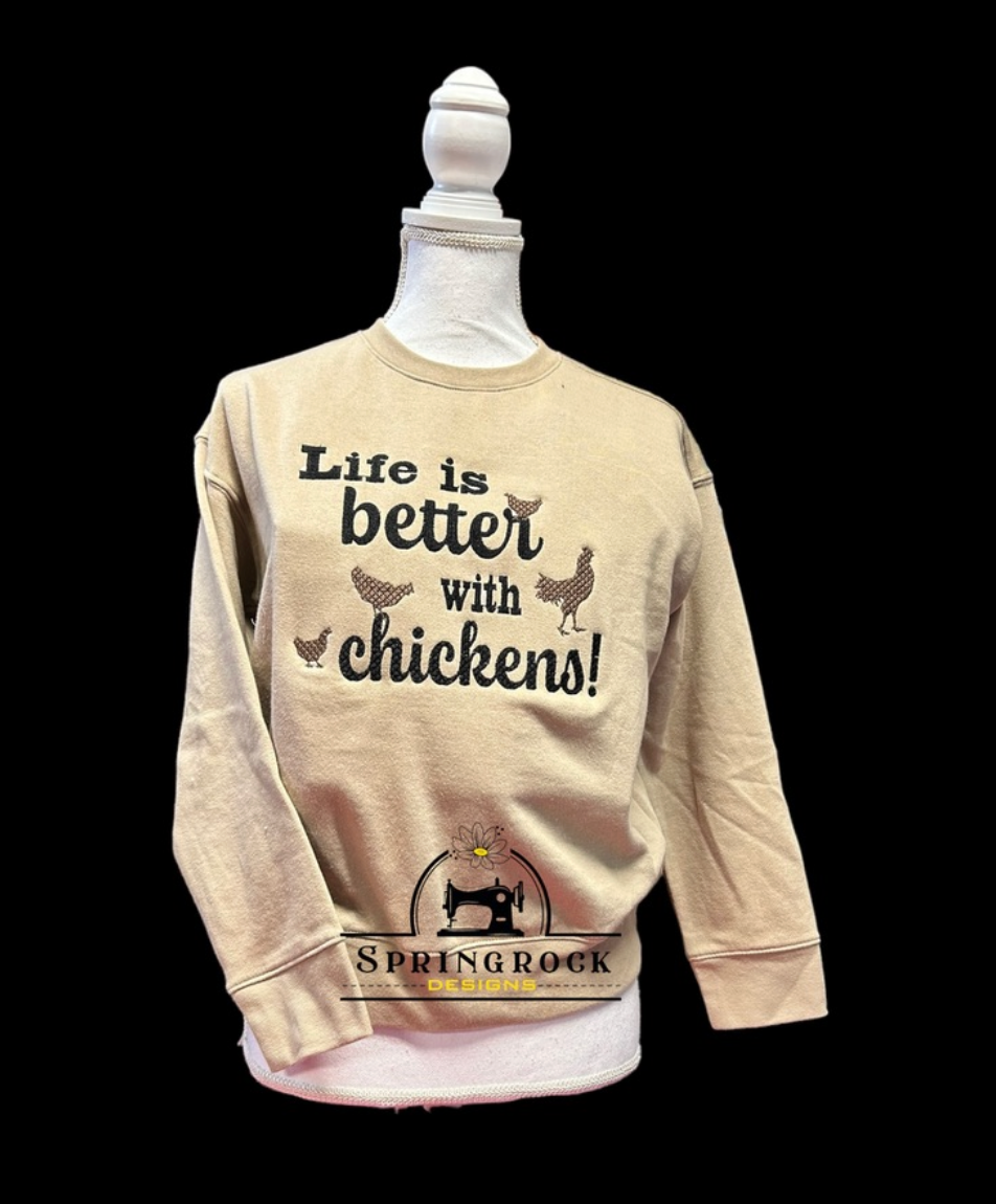 Beige sweatshirt with 'Life is better with chickens!' text on a mannequin against a black background