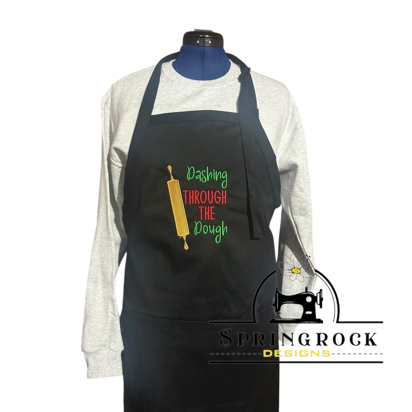 Black apron with colorful text and design on a mannequin, featuring the brand 'Springrock Designs'.