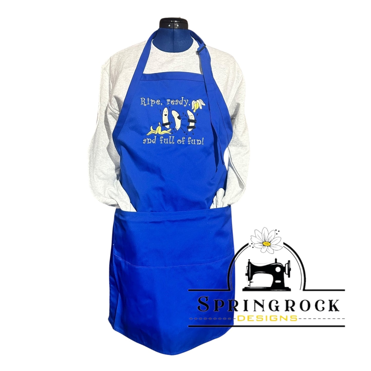 Blue apron with text and  banana cartoon design on a white background, featuring Springrock Designs logo.